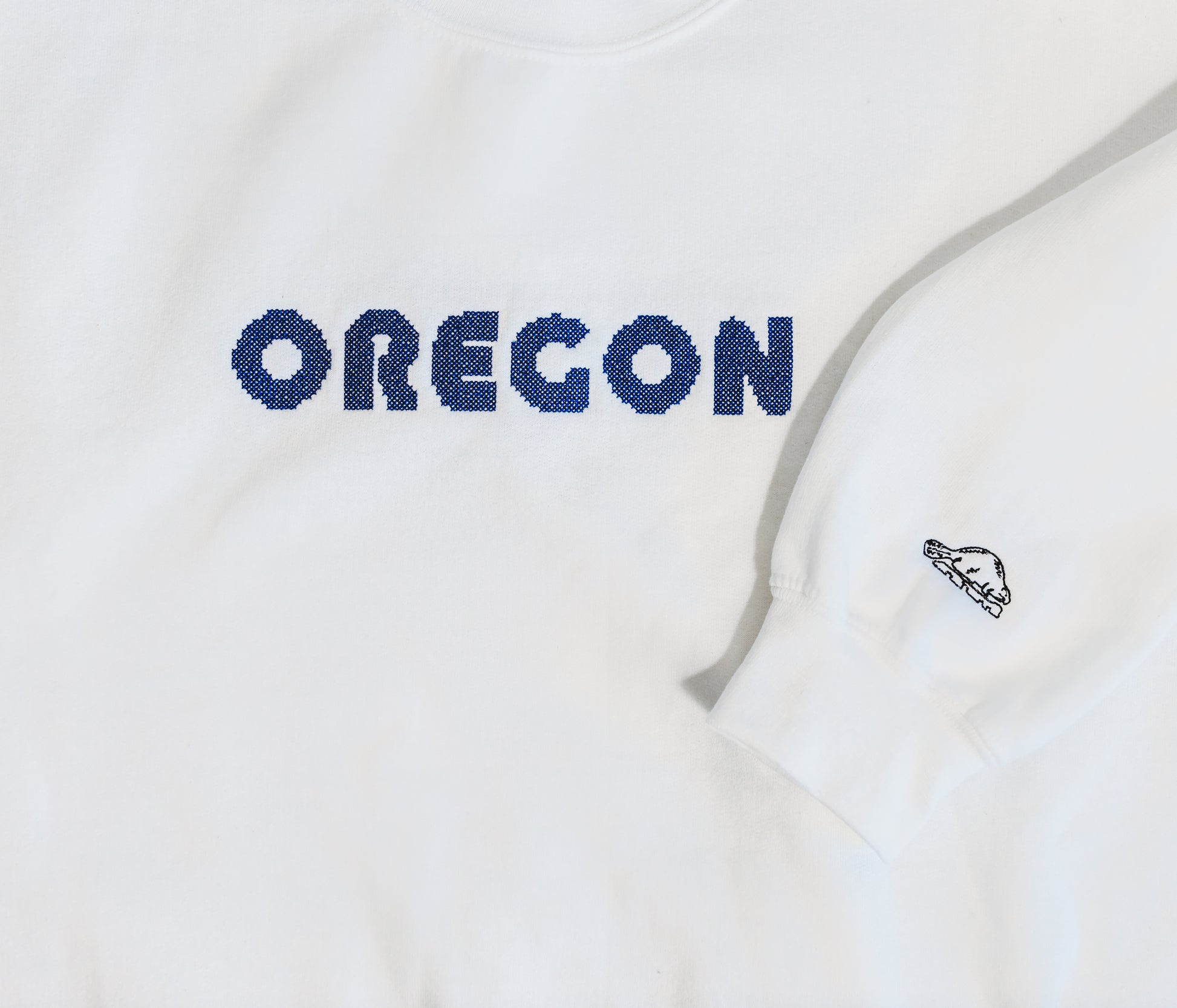 Oregon cross stitch embroidered on crewneck sweatshirt with embroidered beaver sleeve design