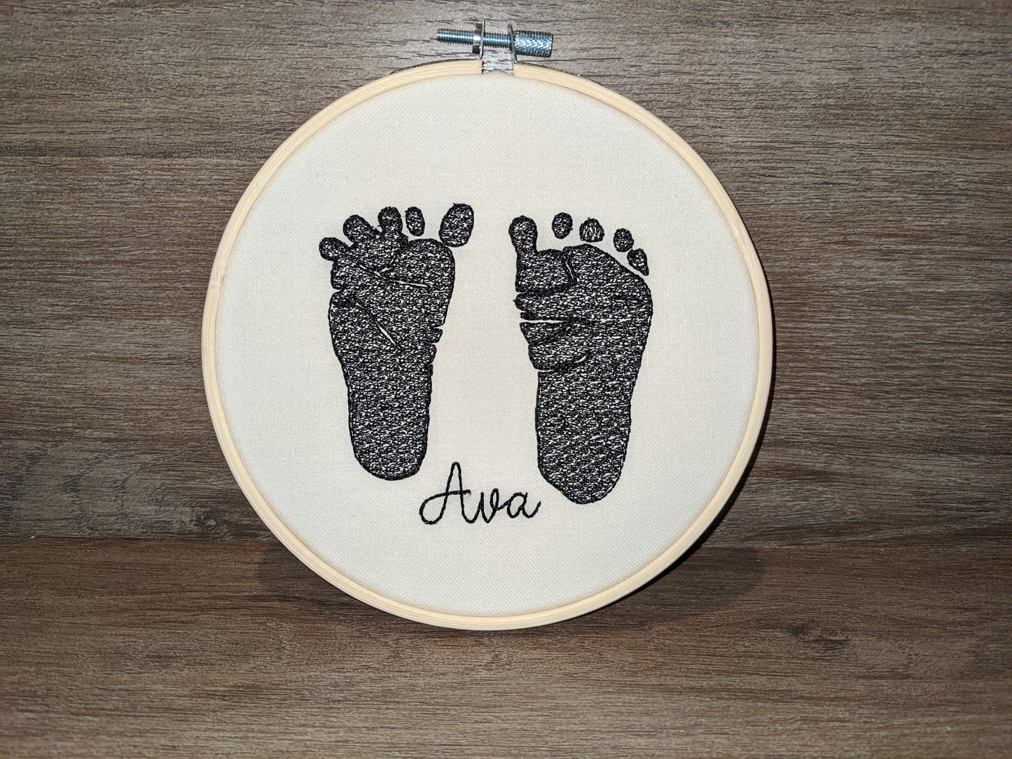 Embroidered baby feet in embroidery hoop