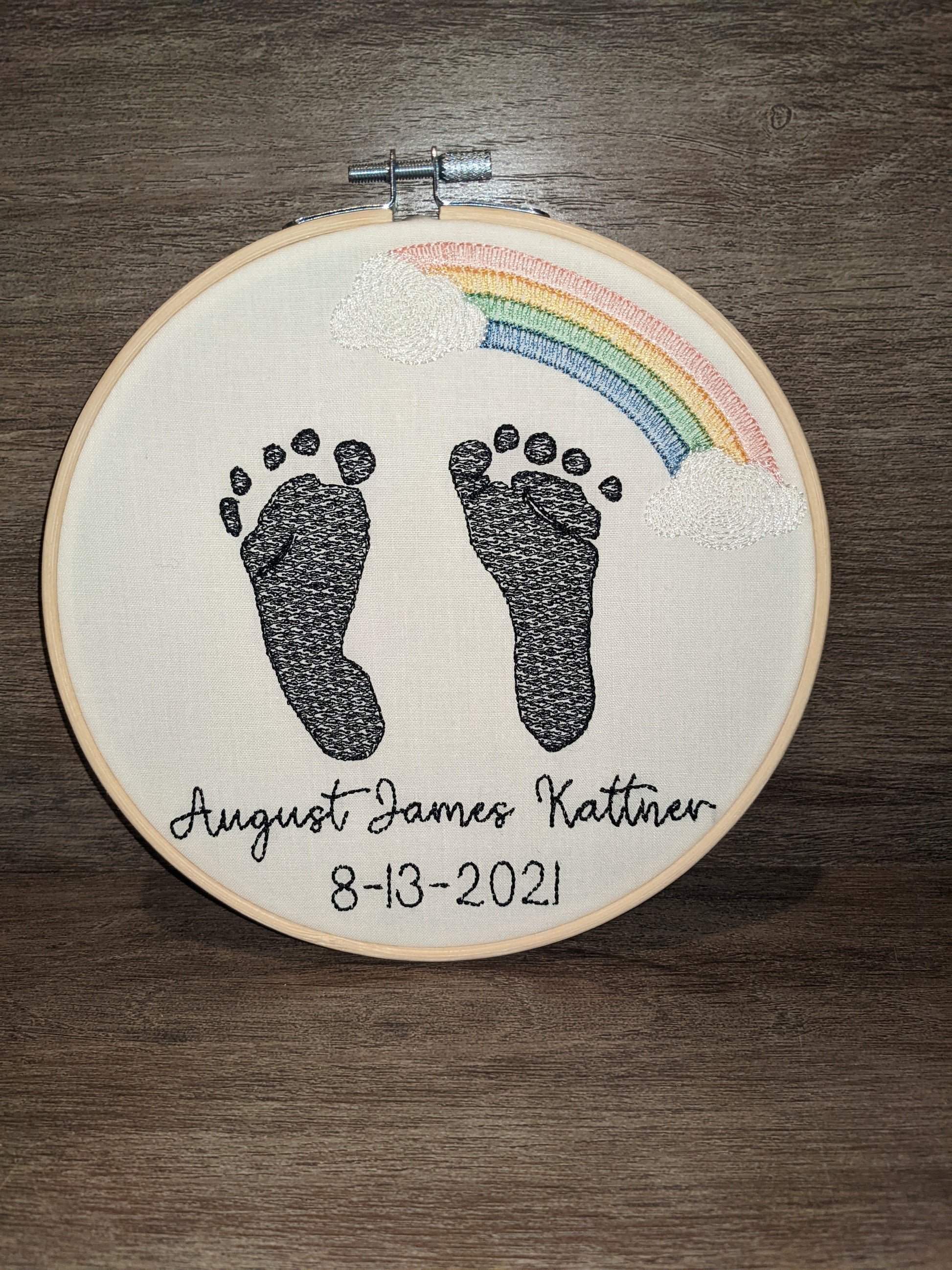Embroidered baby feet with rainbow design