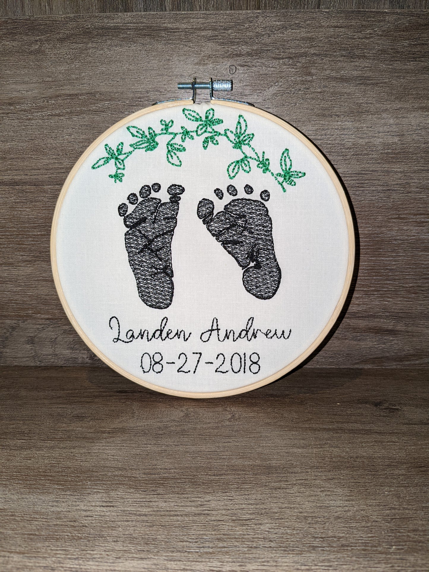 Embroidered baby feet with leaf design
