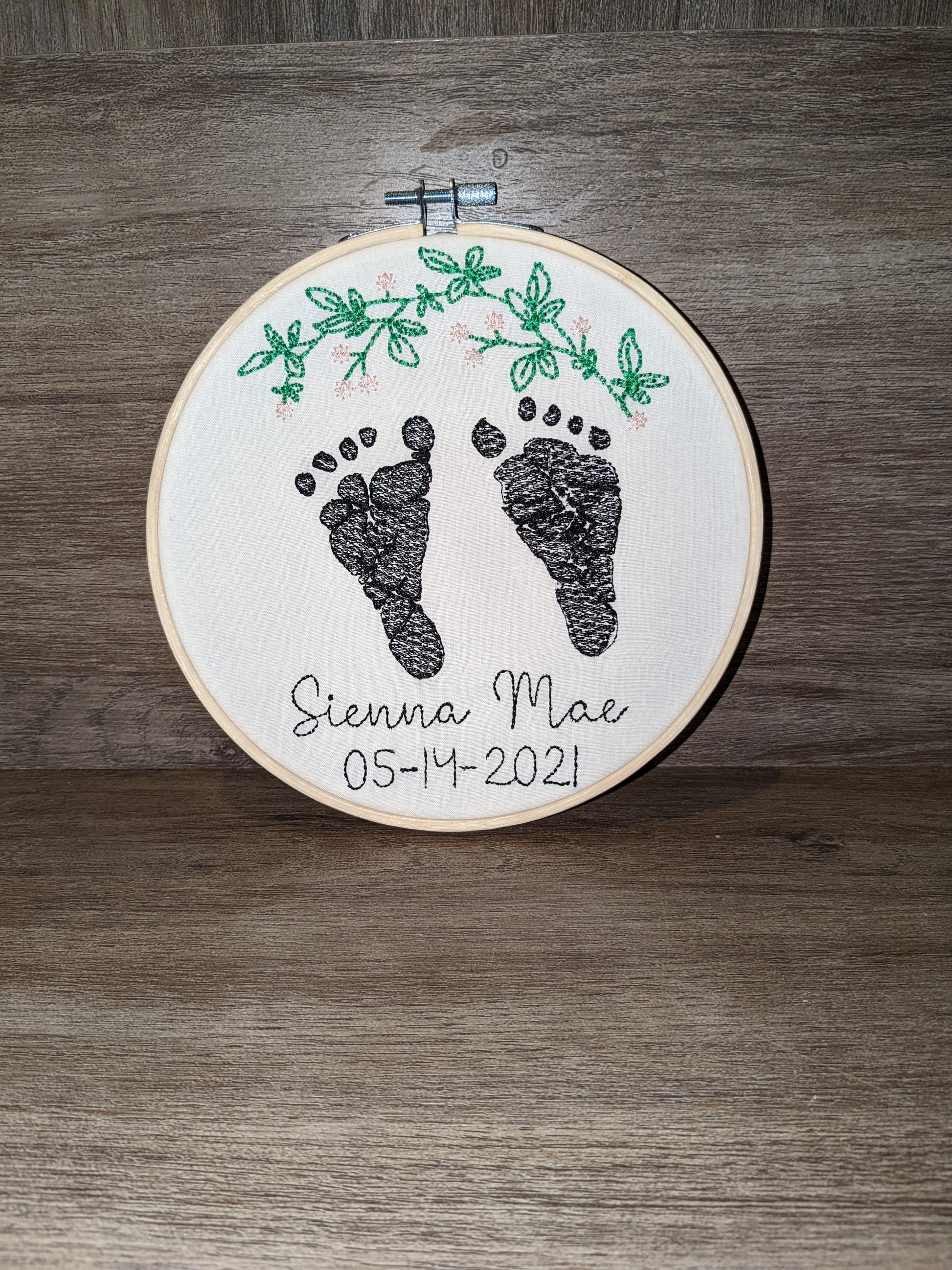 Embroidered baby feet with floral leaf design
