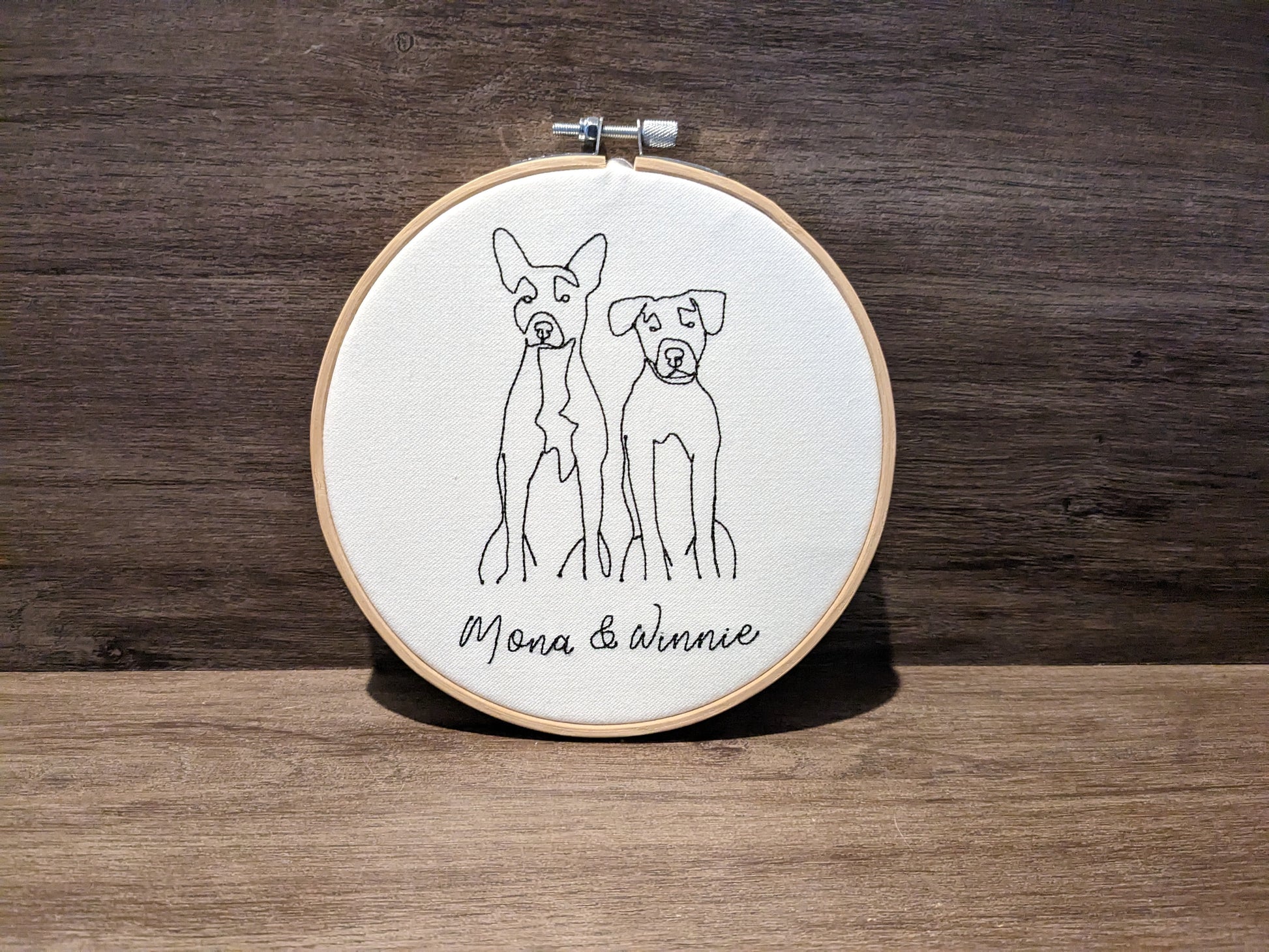 Dogs embroidered line art in embroidery frame