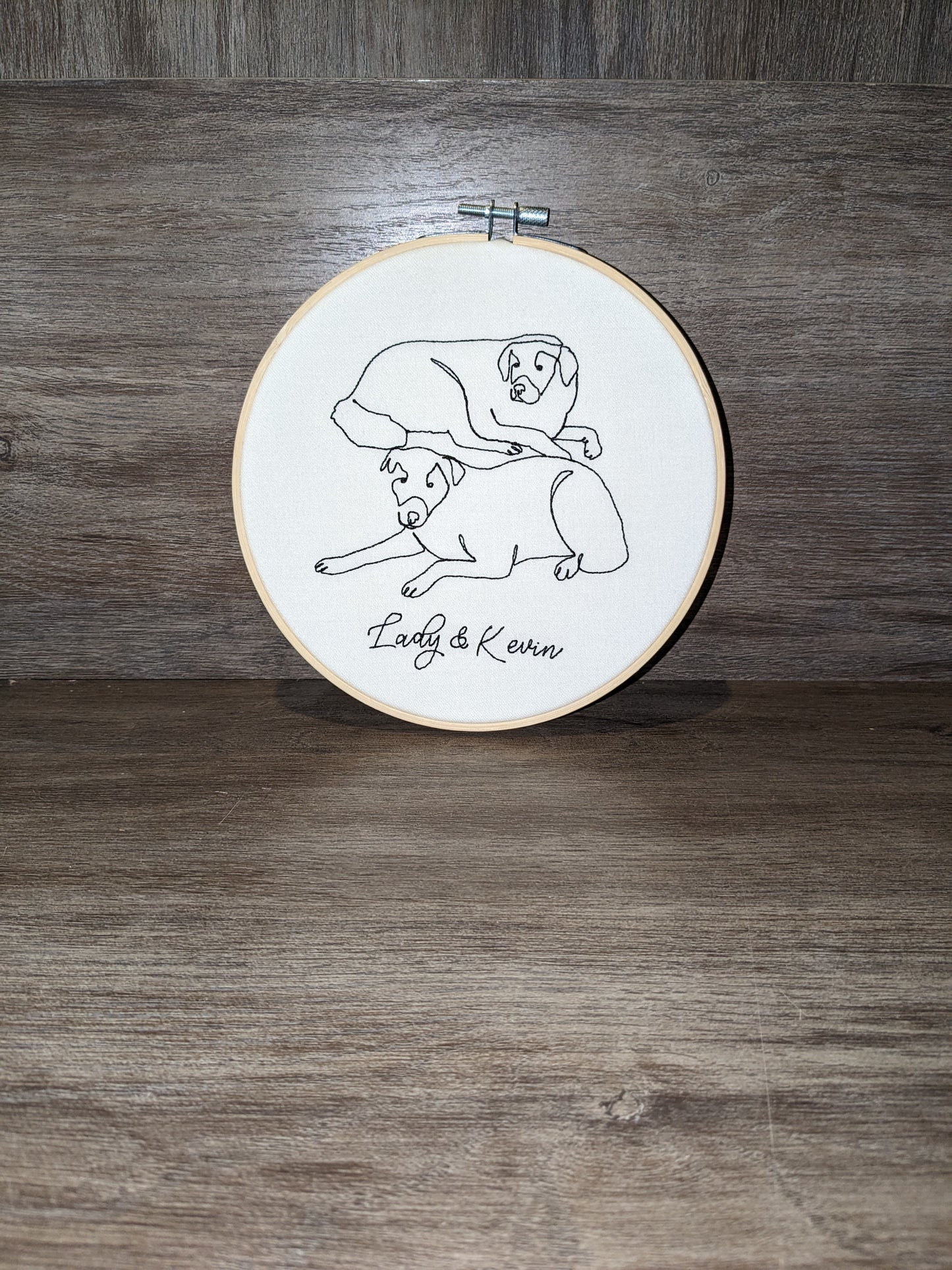 Dogs embroidered line art in embroidery frame