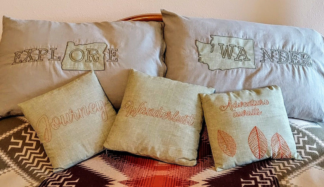 embroidered adventure and WA pillows on bed
