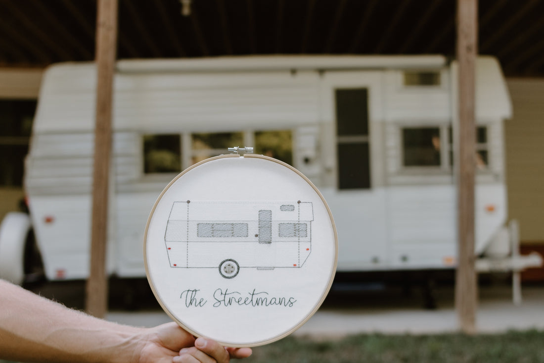 camper embroidery in hoop with actual camper in background