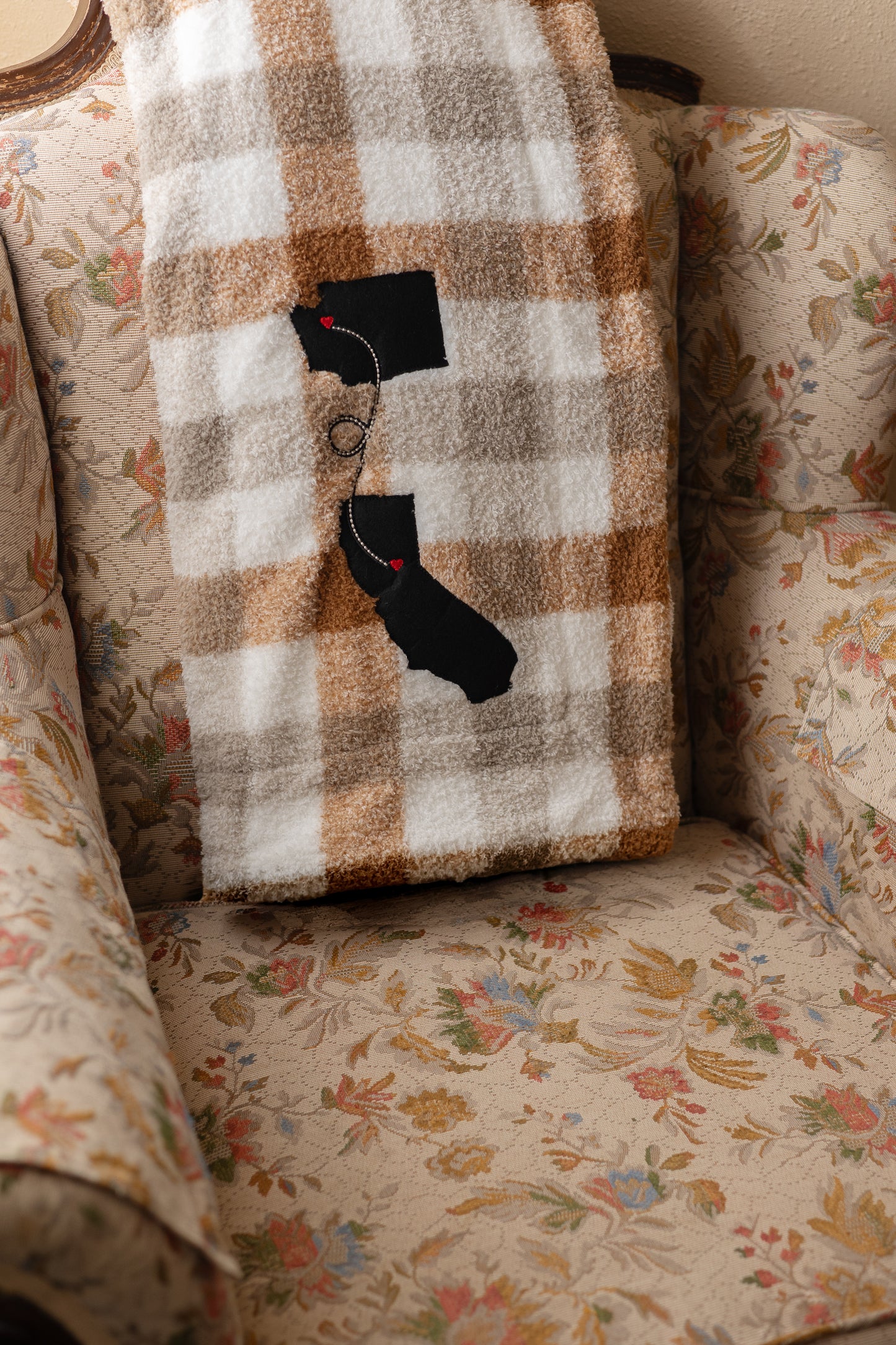 Cozy plaid blanket with a custom two-state long distance design in the corner