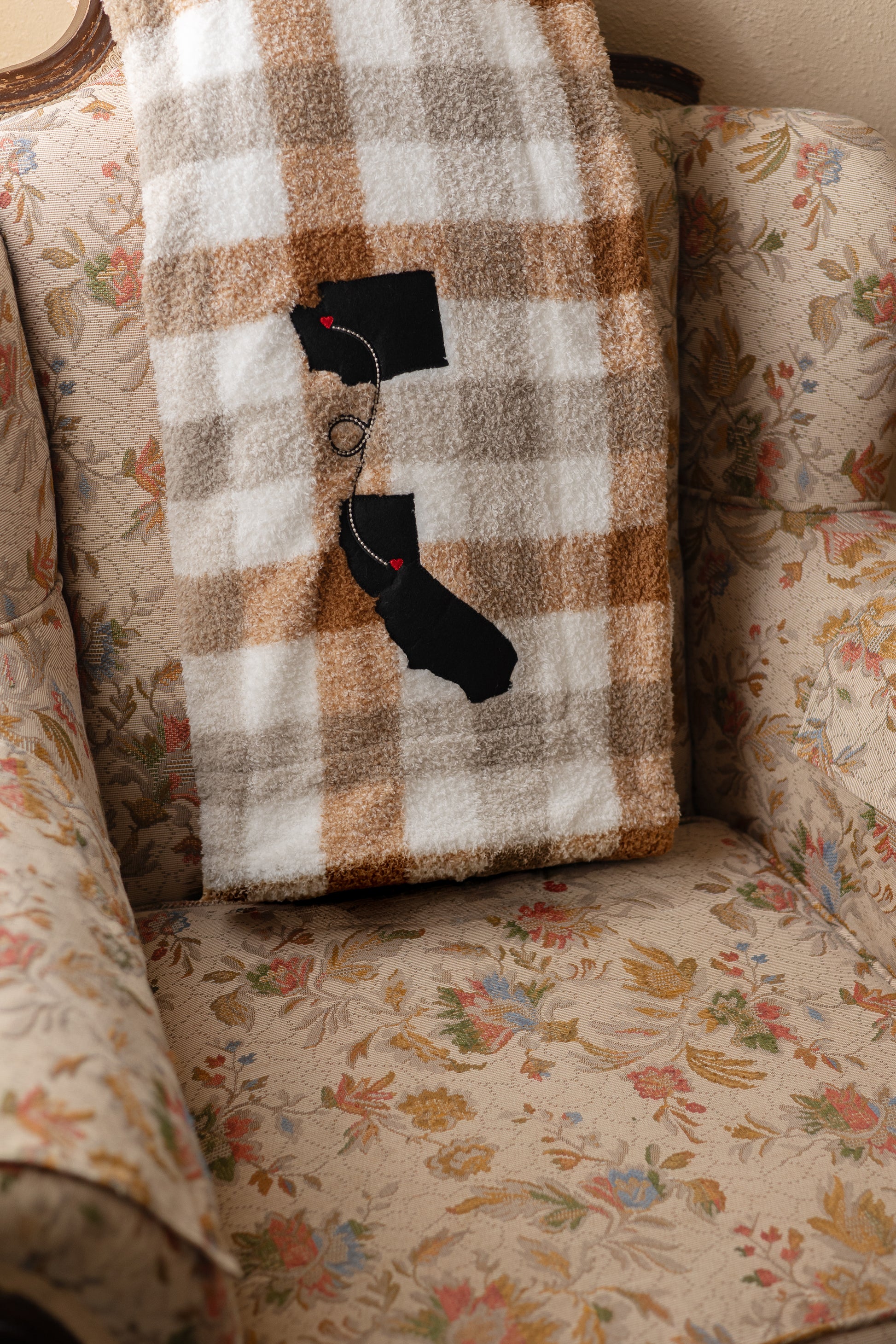 Cozy plaid blanket with a custom two-state long distance design in the corner