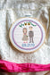 Embroidered cross stitch couple with wedding decor details
