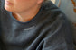 Mama collar embroidered along the neckline of a heather crewneck sweatshirt