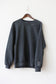 Mama collar sweatshirt with kids' names embroidered on the sleeve, hanging on hanger