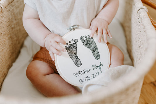 Embroidered baby feet in embroidery hoop