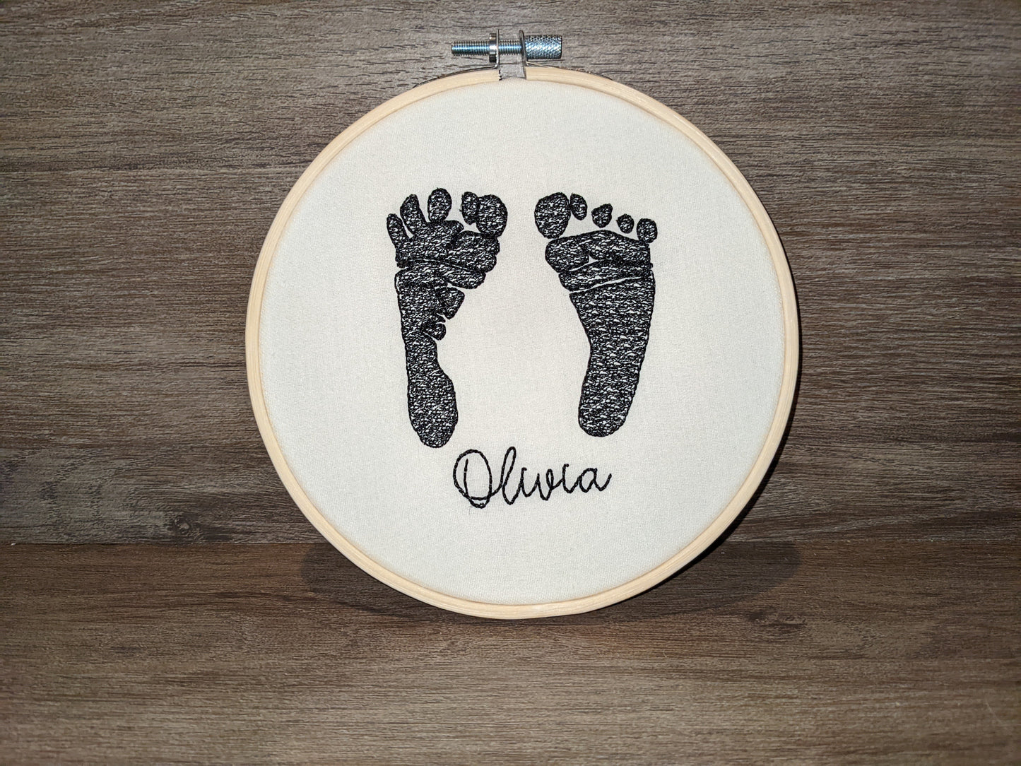 Embroidered baby feet in embroidery hoop