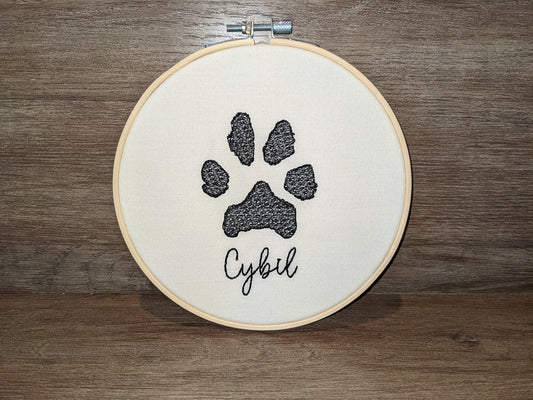 Custom paw print embroidered in a 6 inch wooden hoop