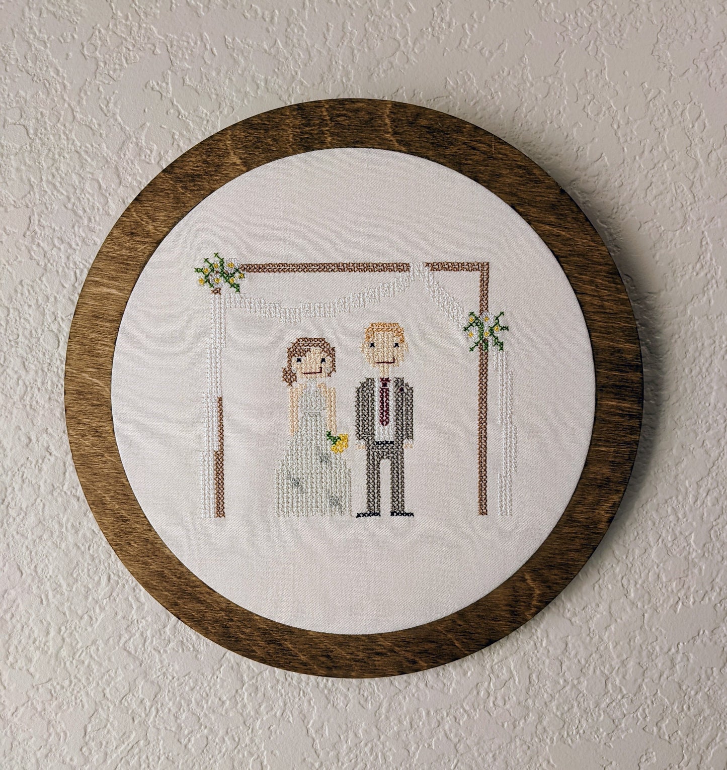 Embroidered cross stitch wedding couple in a wooden frame
