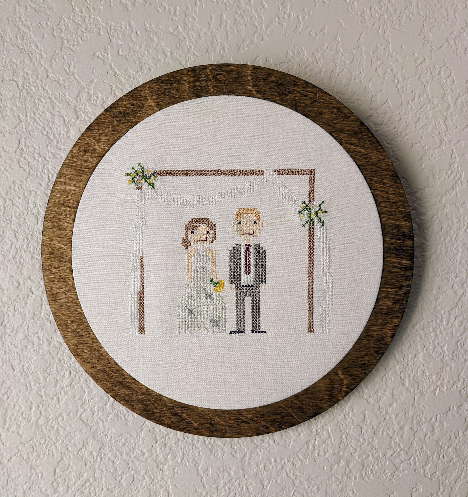 Embroidered cross stitch wedding couple in a wooden frame