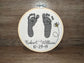 Embroidered baby feet with bee design