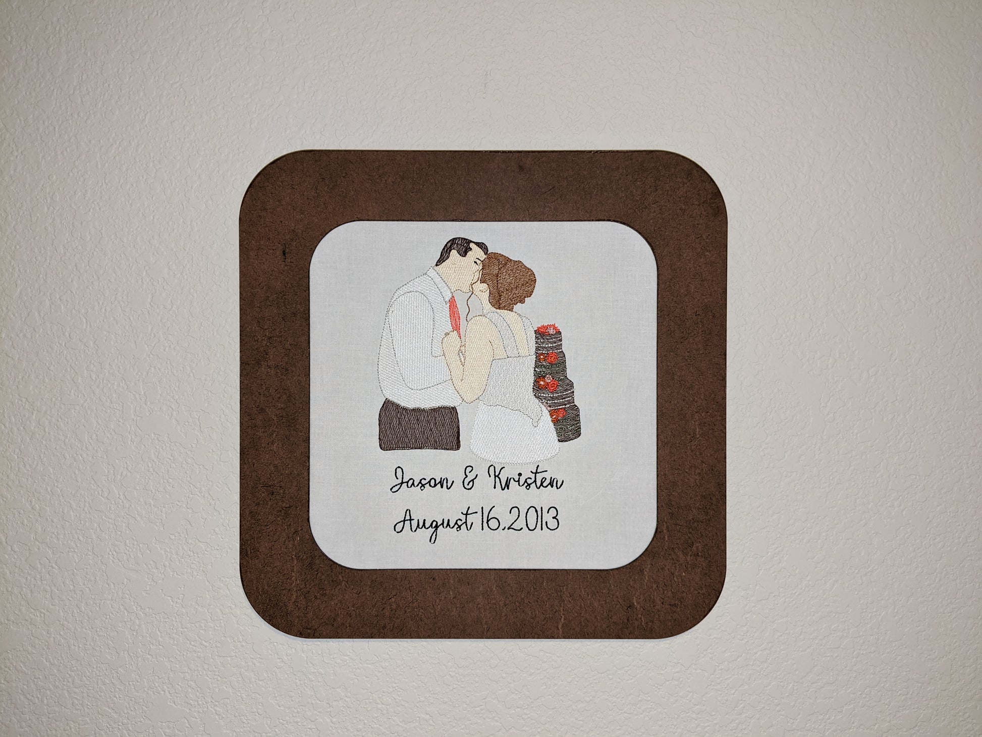 Wedding photo recreated as embroidery in a wooden hoop