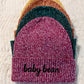 Custom embroidered beanie personalized with a name on the cuff