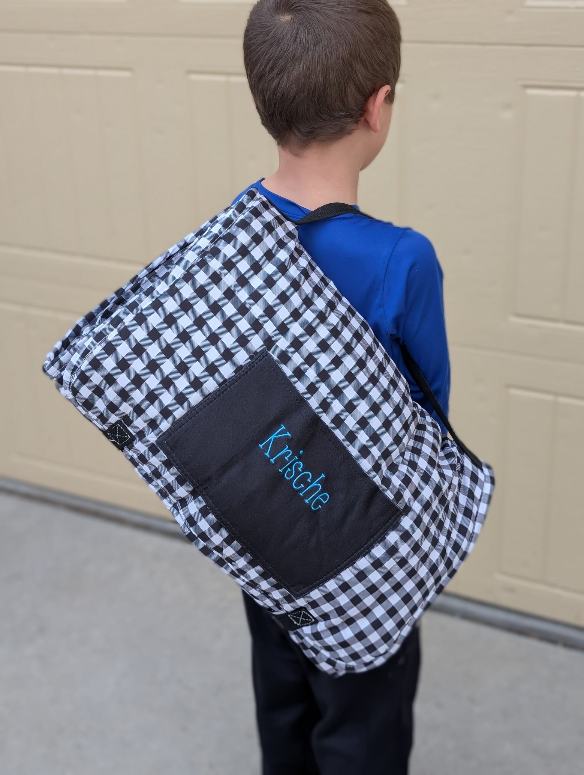 Rolled up daycare nap mat with a child's name embroidered on the outside