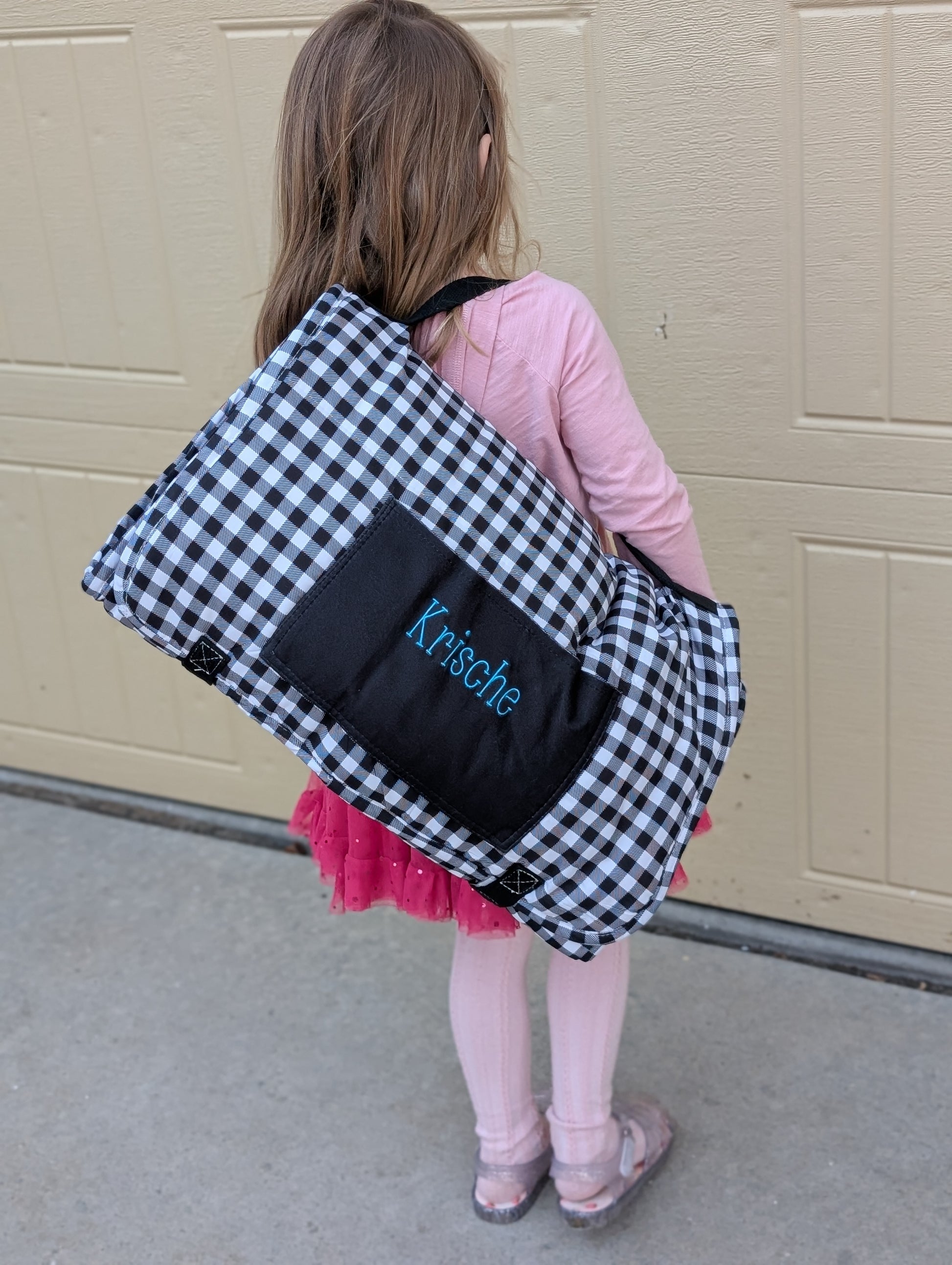 Personalized kids nap mat with an embroidered name on the pocket