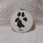 Custom pet paw print embroidered with the dog's name in a hoop keepsake