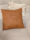 Embroidered pet line art faux leather pillow cover on an accent chair