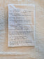 A handwritten recipe card on white paper detailing the preparation of 'Potatoes 3 1/2 POUNDS' with instructions, photographed flat on a textured cream fabric background.